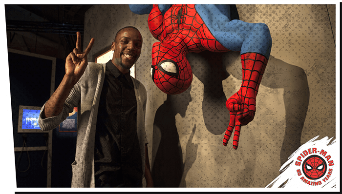 A visitor poses with Spider-man - Beyond Amazing Exhibition